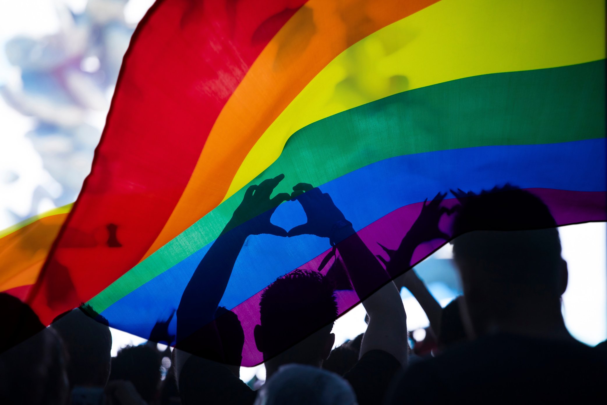 Rainbow Flag Over a Crowd of LGBT People 